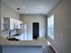 Cozy kitchen with white appliances, lots of cabinetry, and wood-look floors at 1333 Misty Greens Dr, Sun City Center, FL 33573
