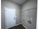 Practical laundry room with wire shelving, utility connections, and neutral wall color, offering functionality at 1333 Misty Greens Dr, Sun City Center, FL 33573