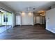 Spacious living room with wood-look flooring and sliding glass doors to patio at 1333 Misty Greens Dr, Sun City Center, FL 33573
