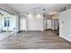 Open living space with neutral walls, laminate floors, and access to an outdoor lanai through sliding glass doors at 1333 Misty Greens Dr, Sun City Center, FL 33573