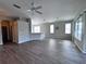 Open living and dining area with wood-look flooring and abundant natural light at 1333 Misty Greens Dr, Sun City Center, FL 33573