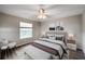 Staged bedroom with wood-look floors, a large window, and an upholstered headboard at 1333 Misty Greens Dr, Sun City Center, FL 33573