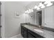 Modern bathroom with double vanity, granite countertops, and stylish light fixtures at 13434 White Sapphire Rd, Riverview, FL 33579