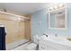 Clean and bright bathroom with shower/tub combo and modern fixtures at 1700 Cove Ii Pl # 310, Sarasota, FL 34242