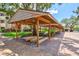 Covered parking area with wood framing and brick pavers at 1700 Cove Ii Pl # 310, Sarasota, FL 34242