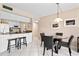 Dining area with glass table and chairs adjacent to the kitchen at 1700 Cove Ii Pl # 310, Sarasota, FL 34242