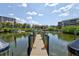 Wooden dock extending into the water with pilings and cleats at 1700 Cove Ii Pl # 310, Sarasota, FL 34242