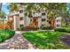 Attractive condo building exterior with lush landscaping and brick walkways at 1700 Cove Ii Pl # 310, Sarasota, FL 34242