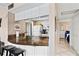 Open kitchen with breakfast bar, white cabinets, and view to bedroom at 1700 Cove Ii Pl # 310, Sarasota, FL 34242