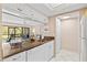 Compact kitchen with granite countertops and view to the living area at 1700 Cove Ii Pl # 310, Sarasota, FL 34242
