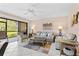 Living room with comfortable seating, a ceiling fan, and sliding glass door at 1700 Cove Ii Pl # 310, Sarasota, FL 34242