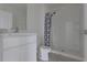 Clean and modern bathroom with shower, white vanity, and tile flooring at 17002 Oval Rum Dr, Wimauma, FL 33598