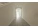 Bright hallway with tile flooring leading to an arched doorway at 17002 Oval Rum Dr, Wimauma, FL 33598