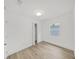 Bright bedroom with wood-look flooring, closet, and window at 1708 E Poinsettia Ave, Tampa, FL 33612