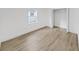 Empty bedroom with wood-look floors, white walls, and closet at 1708 E Poinsettia Ave, Tampa, FL 33612
