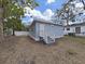 Exterior view of a blue single-story home with white trim and stairs at 1708 E Poinsettia Ave, Tampa, FL 33612