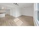 Open living room with wood-look floors, white walls, and recessed lighting at 1708 E Poinsettia Ave, Tampa, FL 33612