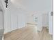 Living area with wood-look flooring, white walls, and access to other rooms at 1708 E Poinsettia Ave, Tampa, FL 33612
