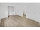 Main bedroom with wood-look flooring, closet, and ensuite bathroom at 1708 E Poinsettia Ave, Tampa, FL 33612