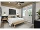 Cozy bedroom with modern ceiling fan, many windows providing lots of natural light, and neutral decor at 17390 Moonflower Dr # 102, Venice, FL 34293