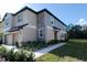 Front exterior view of a two-story home with a stone accent wall at 17534 Nectar Flume Dr, Land O Lakes, FL 34638