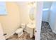 Half bathroom with pedestal sink and tiled floor at 18844 Hampstead Heath Ct, Land O Lakes, FL 34638