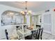Bright dining area with glass table and four chairs, adjacent to kitchen at 20002 Gulf Blvd # 2604, Indian Shores, FL 33785