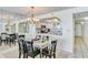 Dining area with glass table and chairs, kitchen and mirrored wall at 20002 Gulf Blvd # 2604, Indian Shores, FL 33785