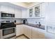 Kitchen with white cabinets, stainless steel appliances, and corner sink at 20002 Gulf Blvd # 2604, Indian Shores, FL 33785