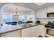 Kitchen with stainless steel appliances and white cabinets, ocean view at 20002 Gulf Blvd # 2604, Indian Shores, FL 33785