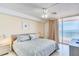 Main bedroom with ocean view, king-size bed, and ceiling fan at 20002 Gulf Blvd # 2604, Indian Shores, FL 33785