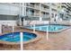 Community pool and hot tub with lounge chairs at 20002 Gulf Blvd # 2604, Indian Shores, FL 33785