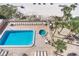 Community pool and hot tub area with lounge chairs at 20002 Gulf Blvd # 2604, Indian Shores, FL 33785