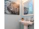 Small bathroom with pedestal sink and zebra artwork at 207 28Th N Ave, St Petersburg, FL 33704