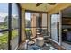Screened-in balcony with serene views of a community pond at 2400 Feather Sound Dr # 515, Clearwater, FL 33762