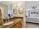 Bathroom vanity with granite countertop, and view of the bedroom at 2400 Feather Sound Dr # 515, Clearwater, FL 33762