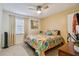 Bedroom with floral bedding, ceiling fan, and window with blinds at 2400 Feather Sound Dr # 515, Clearwater, FL 33762