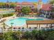 Community pool area with lounge chairs, pergola, tennis court, and clubhouse at 2400 Feather Sound Dr # 515, Clearwater, FL 33762