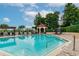 Inviting community pool with a gazebo and lounge chairs at 2400 Feather Sound Dr # 515, Clearwater, FL 33762