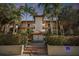 Attractive building with a fountain and lush landscaping at dusk at 2400 Feather Sound Dr # 515, Clearwater, FL 33762