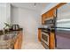 Kitchen with stainless steel appliances, granite countertops, and wood cabinets at 2400 Feather Sound Dr # 515, Clearwater, FL 33762