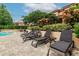 Poolside lounge chairs with pavers and lush landscaping at 2400 Feather Sound Dr # 515, Clearwater, FL 33762