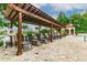 Pool with wooden pergola, lounge chairs, and railing overlooking the pond at 2400 Feather Sound Dr # 515, Clearwater, FL 33762