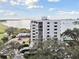 Aerial view of a waterfront condo building next to a golf course at 4 Belleview Blvd # 801, Belleair, FL 33756