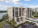 Aerial view of a condo building with balconies, parking, and landscaping at 4 Belleview Blvd # 801, Belleair, FL 33756