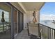 Balcony with sliding glass doors, patio furniture, and breathtaking water views at 4 Belleview Blvd # 801, Belleair, FL 33756