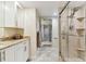 Elegant bathroom featuring white cabinetry, granite countertops, and a glass shower at 4 Belleview Blvd # 801, Belleair, FL 33756