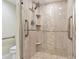 Modern walk-in shower with glass door, tile surround, and safety bars at 4 Belleview Blvd # 801, Belleair, FL 33756