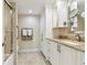 Bright bathroom with a granite countertop vanity and a walk-in shower at 4 Belleview Blvd # 801, Belleair, FL 33756