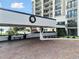 Covered entrance to a condo building with brick driveway and holiday wreath at 4 Belleview Blvd # 801, Belleair, FL 33756